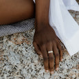 Woman wearing an ethical gold stacking ring. This minimalist Traveller's Set is handmade in Cape Town in recycled gold from e-waste.