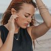 Woman wearing eco-friendly silver pendant. This artisan crafted Double Cube Pendant is handmade in Cape Town in recycled silver from e-waste.