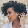 Woman wearing ethical silver earrings. These eco-friendly Vessel Studs are handmade in Cape Town in recycled silver from e-waste.